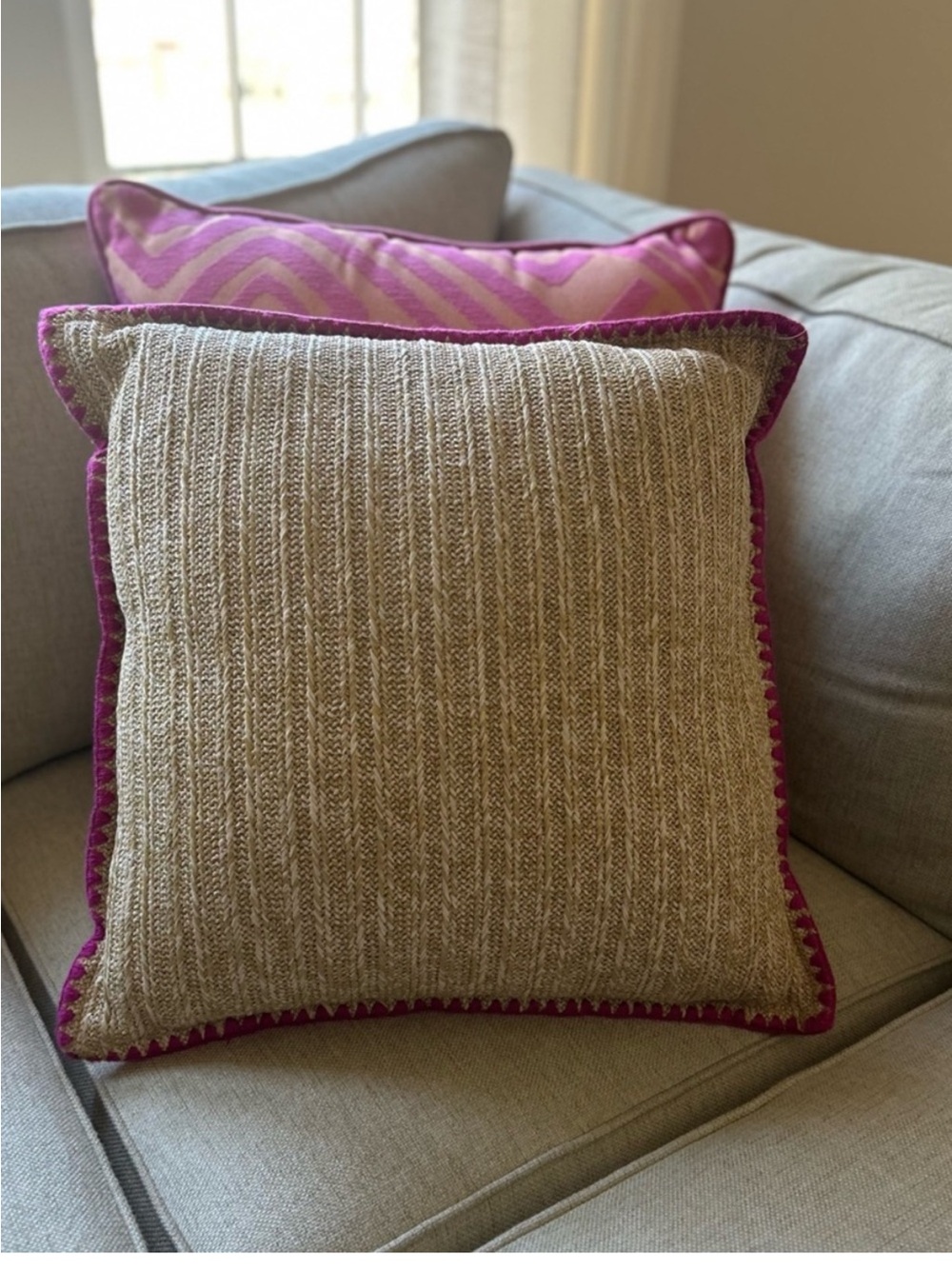 20” x 20” straw pillow with magenta threading